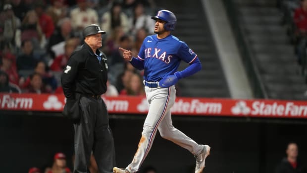May 6, 2023; Anaheim, California, USA; Texas Rangers left fielder Bubba Thompson (8) gestures after scoring against the Los Angeles Angels in the ninth inning at Angel Stadium.
