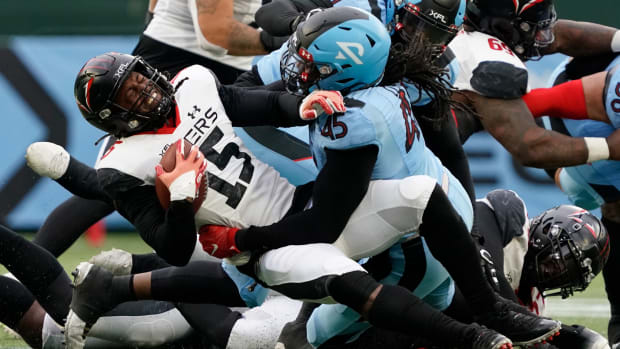 Feb 18, 2023; Arlington, TX, USA; Vegas Vipers running back Rod Smith (15) is tackled by Arlington Renegades defensive lineman Will Clarke (45) during the second half at Choctaw Stadium. Mandatory Credit: Raymond Carlin III-USA TODAY Sports  
