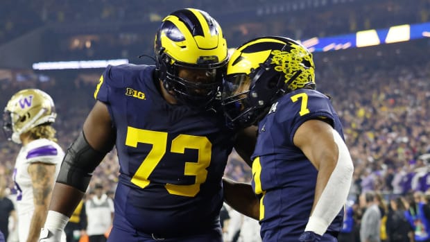Jan 8, 2024; Houston, TX, USA; Michigan Wolverines running back Donovan Edwards (7) celebrates with Michigan Wolverines offensive lineman LaDarius Henderson (73) after scoring a touchdown against the Washington Huskies during the first quarter in the 2024 College Football Playoff national championship game at NRG Stadium.
