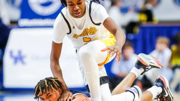 Woodford County point guard Jasper Johnson battles Warren Central guard Damarion Walkup for control of the ball in the second half of Saturday's KHSAA Boys Sweet 16 semifinal. The Yellowjackets fell to the Dragons 56-48. March 18, 2023