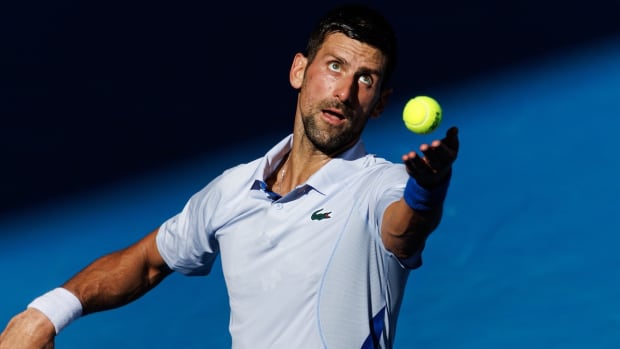 Jan 23, 2024; Melbourne, Victoria, Australia; Novak Djokovic of Serbia in action against Taylor Fritz of the United States in the quarterfinal of the men’s singles. Mandatory Credit: Mike Frey-USA TODAY Sports