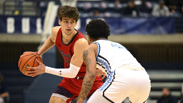 Feb 16, 2023; San Diego, California, USA; Saint Mary's Gaels guard Aidan Mahaney (20) controls the ball while defended by San Diego Toreros guard Deuce Turner (4) during the first half at Jenny Craig Pavilion. 