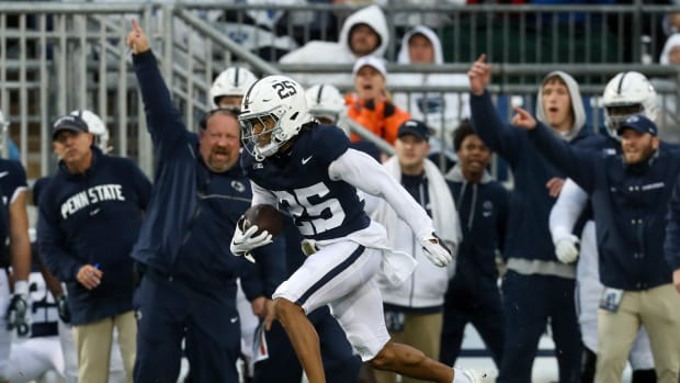 Penn State's Daequan Hardy returns a punt for a touchdown against Massachusetts as special teams coordinator Stacy Collins cheers from the sideline.