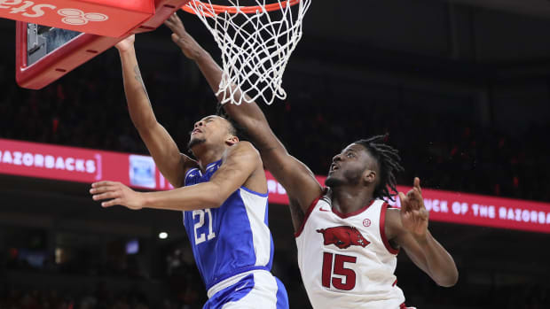 Jan 27, 2024; Fayetteville, Arkansas, USA; Kentucky Wildcats guard D.J. Wagner (21) drives to the basket during the first half as Arkansas Razorbacks forward Makhi Mitchell (15) defends at Bud Walton Arena. Mandatory Credit: Nelson Chenault-USA TODAY Sports