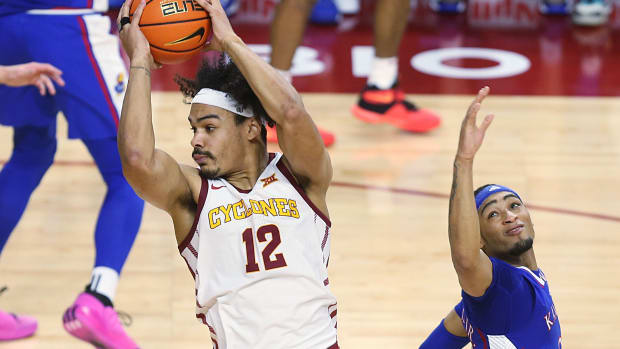 Iowa State Cyclones forward Robert Jones (12) drives to the basket around Kansas Jayhawks guard Dajuan Harris Jr. (3)during the first half in the Big-12 conference showdown of an NCAA college basketball at Hilton Coliseum on Saturday, Jan. 27, 2024, in Ames, Iowa.