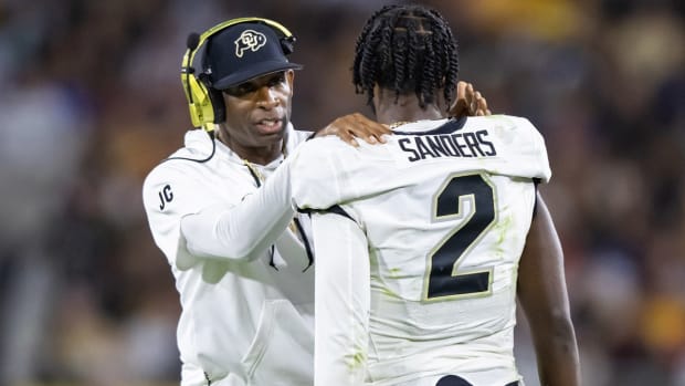 Colorado Buffaloes coach Deion Sanders chats with his son and quarterback Shedeur Sanders against Arizona State.
