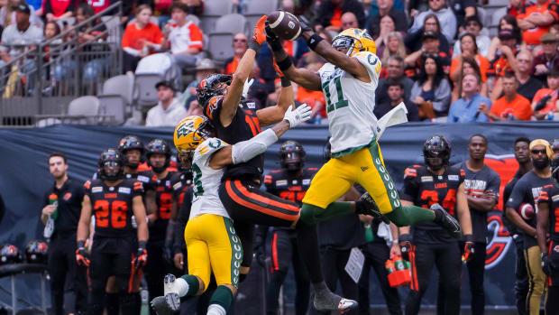 Jun 17, 2023; Vancouver, British Columbia, CAN; Edmonton Elks linebacker Enock Makonzo (43) watches as defensive back Ed Gainey (11) intercepts a pass intended for BC Lions receiver Justin McInnis (18) during the first half in at BC Place. Mandatory Credit: Bob Frid-USA TODAY Sports  