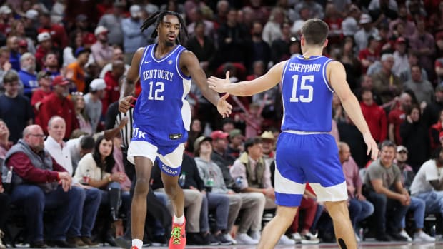 Jan 27, 2024; Fayetteville, Arkansas, USA; Kentucky Wildcats guard Antonio Reeves (12) celebrates with guard Reed Sheppard (15) after making a three point shot in the second half against the Arkansas Razorbacks at Bud Walton Arena. Kentucky won 63-57. Mandatory Credit: Nelson Chenault-USA TODAY Sports