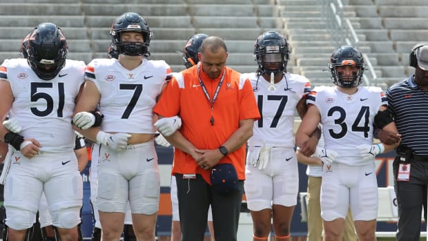 Tony Elliott and his players link arms after the Virginia football spring game at Scott Stadium.