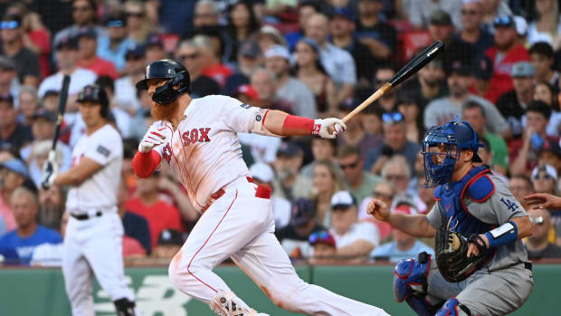 Aug 26, 2023; Boston, Massachusetts, USA; Boston Red Sox first baseman Justin Turner (2) hits an RBI single against the Los Angeles Dodgers during the seventh inning at Fenway Park.