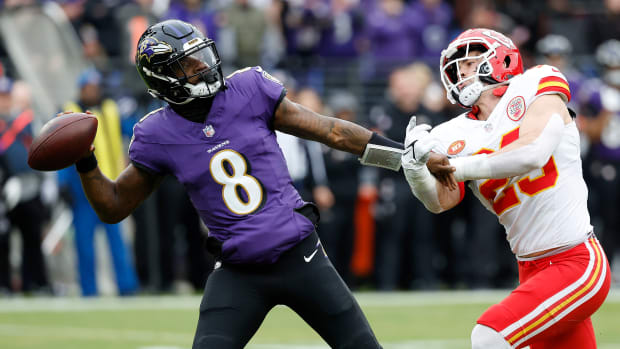 Baltimore Ravens quarterback Lamar Jackson  prepares to throw the ball as Kansas City Chiefs linebacker Drue Tranquill defends during the first half in the AFC championship game at M&T Bank Stadium.