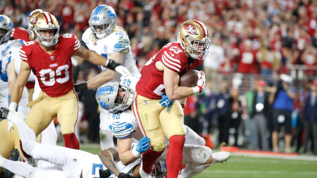 49ers running back Christian McCaffrey runs the ball in for a touchdown in the third quarter of the Lions' 34-31 loss in the NFC championship game in Santa Clara, California, on Sunday, Jan. 28, 2024.