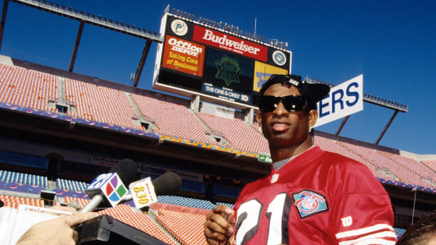 Jan 24, 1995; Miami, FL, USA; FILE PHOTO; San Francisco 49ers cornerback Deion Sanders (21) talks with media during media day prior to Super Bowl XXIX against the San Diego Chargers at Joe Robbie Stadium. The 49ers defeated the Chargers 49-26