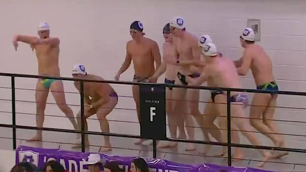 The Holy Cross men’s swim team tries to distract a Boston University player shooting free throws during a Jan. 29, 2024 game.