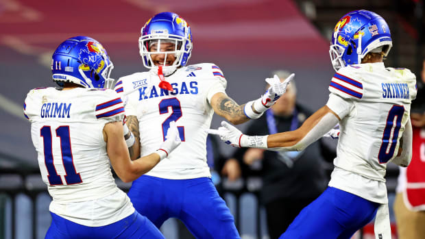 Dec 26, 2023; Phoenix, AZ, USA; Kansas Jayhawks wide receiver Lawrence Arnold (2) celebrates with wide receiver Luke Grimm (11) and wide receiver Quentin Skinner (0) during the second half against the UNLV Rebels in the Guaranteed Rate Bowl at Chase Field. Mandatory Credit: Mark J. Rebilas-USA TODAY Sports  