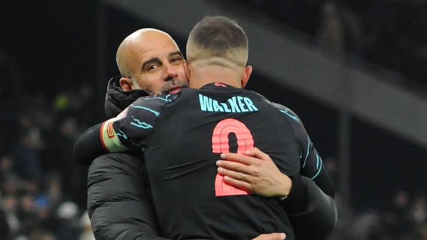 Manchester City manager Pep Guardiola pictured (left) hugging Kyle Walker following a 1-0 win at Tottenham Hotspur in January 2024