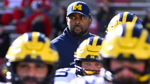Michigan Wolverines head coach Sherrone Moore with his team before a college football game in the Big Ten.