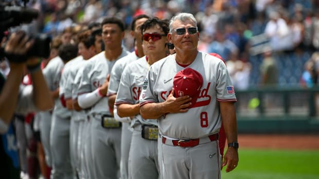 Jun 17, 2023; Omaha, NE, USA; Stanford Cardinal head coach David Esquer (8) stands for the national anthem before a game against the Wake Forest Demon Deacons at Charles Schwab Field Omaha. Mandatory Credit: Steven Branscombe-USA TODAY Sports 