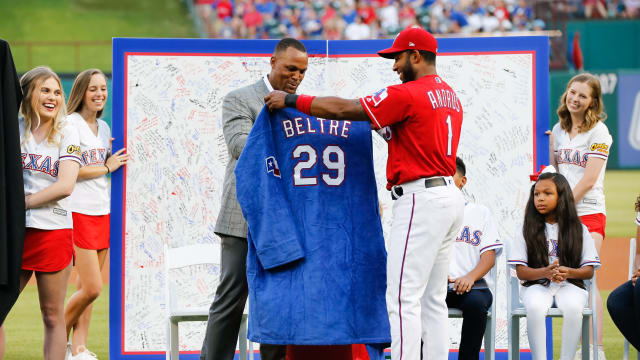 Texas Rangers legend Adrian Beltre is given a retirement robe from shortstop Elvis Andrus in June 2019 during a ceremony retiring his uniform No. 29 prior at Globe Life Park in Arlington. Beltre, who was elected to the National Baseball Hall of Fame earlier this month, will wear a Rangers cap in his Hall of Fame plaque.