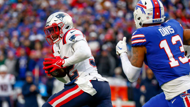 New England Patriots safety Devin McCourty (32) runs back an interception during the first half of an NFL football game against the Buffalo Bills, Sunday, Jan. 8, 2023, in Orchard Park.
