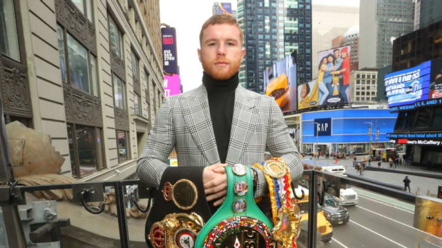 Canelo Alvarez poses for a photo in New York City and showcases his undisputed super-middleweight boxing titles.