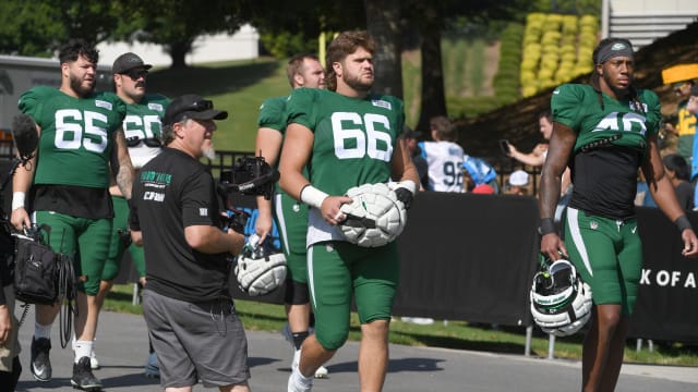 Jets' players, including Joe Tippmann (66) walked to the practice field in Spartanburg, SC