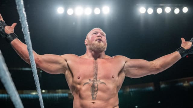Brock Lesnar poses with his arms out during WWE live event.