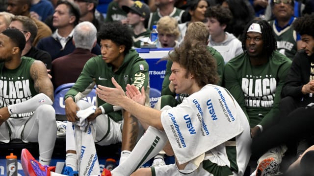 Milwaukee Bucks center Robin Lopez (42) cheers for his team from the bench during the second quarter against the Dallas Mavericks