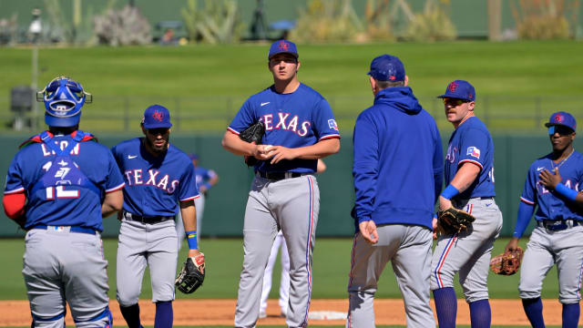 Texas Rangers pitcher Owen White waits on the mound as he is pulled by manager Bruce Bochy from the fourth inning during a spring training game on Feb. 24, 2023, at Surprise Stadium in Surprise, Ariz.