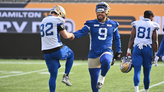 Nov 16, 2023; Hamilton, Ontario, CAN; Winnipeg Blue Bombers defensive tackle Ricky Walker (9) stretches with wide receiver Drew Wolltarsky (82) during practice at Tim Hortons Field. Mandatory Credit: Dan Hamilton-USA TODAY Sports  