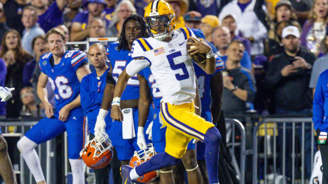 Nov 11, 2023; Baton Rouge, Louisiana, USA; LSU Tigers quarterback Jayden Daniels (5) rushes for a touchdown against the Florida Gators during the first half at Tiger Stadium.