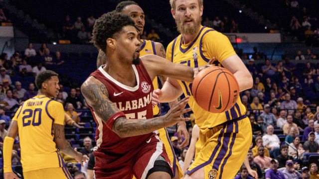 Feb 10, 2024; Baton Rouge, Louisiana, USA; Alabama Crimson Tide guard Aaron Estrada (55) passes the ball against LSU Tigers forward Hunter Dean (12) during the second half at Pete Maravich Assembly Center. Mandatory Credit: Stephen Lew-USA TODAY Sports  