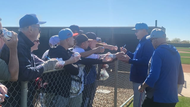 Texas Rangers manager Bruce Bochy signs autographs during the club's first day of spring training camp in Surprise, Ariz. Pitchers and catchers reported Wednesday. Position players report by Monday.