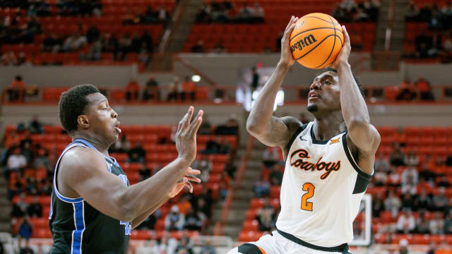 Oklahoma State Cowboys forward Eric Dailey Jr. (2) shoots the ball over Brigham Young Cougars forward Fousseyni Traore (45) during the first half at Gallagher-Iba Arena. 