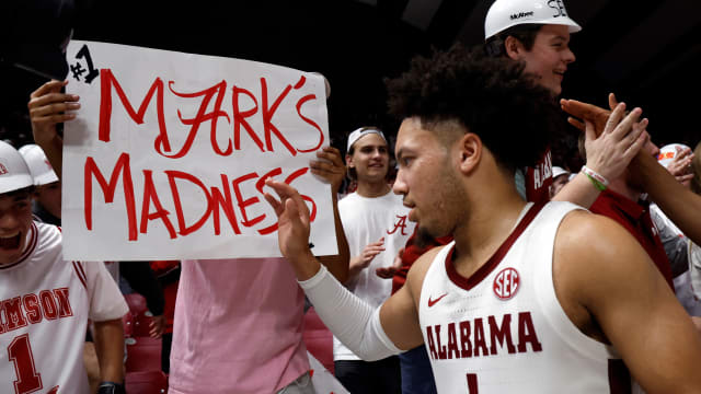 Feb 21, 2024; Tuscaloosa, Alabama, USA; Alabama Crimson Tide guard Mark Sears (1) celebrates with fans after they beat the Florida Gators in overtime at Coleman Coliseum. Mandatory Credit: Butch Dill-USA TODAY Sports  
