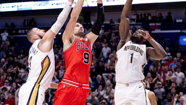 Chicago Bulls center Nikola Vucevic (9) drives to the basket against New Orleans Pelicans forward Zion Williamson (1) and center Jonas Valanciunas (17) during the second half at Smoothie King Center.