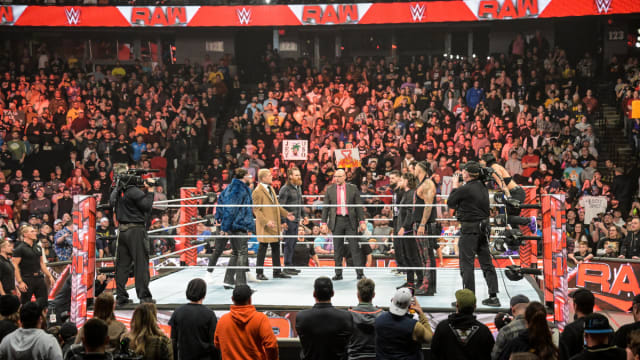 Top WWE superstars such as Cody Rhodes and Seth Rollins are inside the ring with WWE Raw General Manager Adam Pearce.
