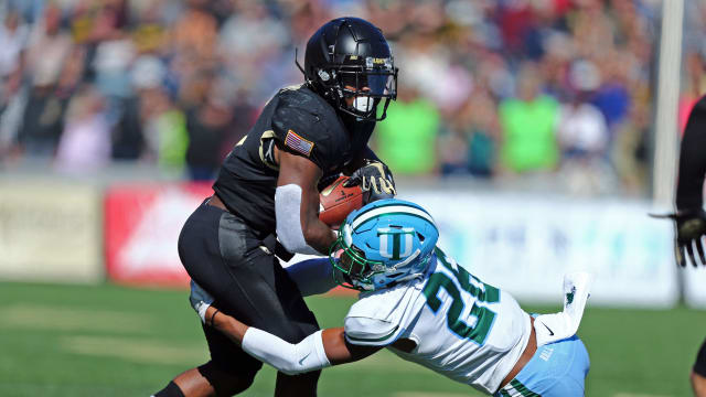 Oct 5, 2019; West Point, NY, USA; Army Black Knights running back Kell Walker (5) is tackled by Tulane Green Wave Thakarius Keyes cornerback (26) during the first half at Michie Stadium. Mandatory Credit: Danny Wild-USA TODAY Sports  