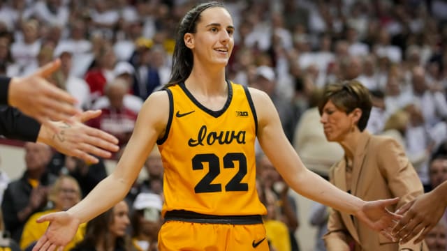 Iowa Hawkeyes guard Caitlin Clark high-fives teammates as she takes the court before a game against the Indiana Hoosiers at Simon Skjodt Assembly Hall.