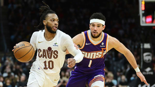 Mar 11, 2024; Cleveland, Ohio, USA; Cleveland Cavaliers guard Darius Garland (10) drives to the basket against Phoenix Suns guard Devin Booker (1) during the second half at Rocket Mortgage FieldHouse.