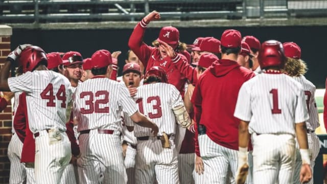 Alabama baseball celebrates a wild play that resulted in Bryce Eblin (13) scoring.