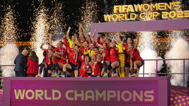 Spain's women's national team celebrates on stage after winning the Women's World Cup.