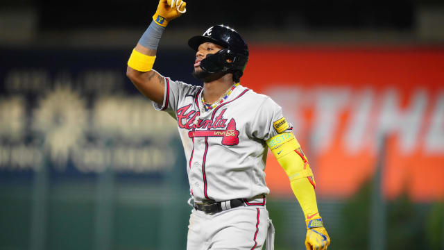 Aug 29, 2023; Denver, Colorado, USA; Atlanta Braves right fielder Ronald Acuna Jr. (13) reacts to his single in the fifth inning against the Colorado Rockies at Coors Field.