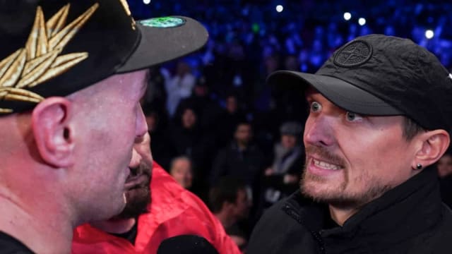 Boxing heavyweight champions Tyson Fury and Oleksandr Usyk engage in a staredown.