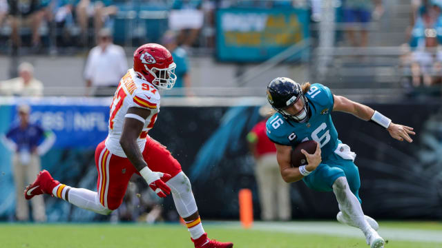 Sep 17, 2023; Jacksonville, Florida, USA; Jacksonville Jaguars quarterback Trevor Lawrence (16) runs with the ball chased by Kansas City Chiefs defensive end Felix Anudike-Uzomah (97) in the second quarter at EverBank Stadium. Mandatory Credit: Nathan Ray Seebeck-USA TODAY Sports  