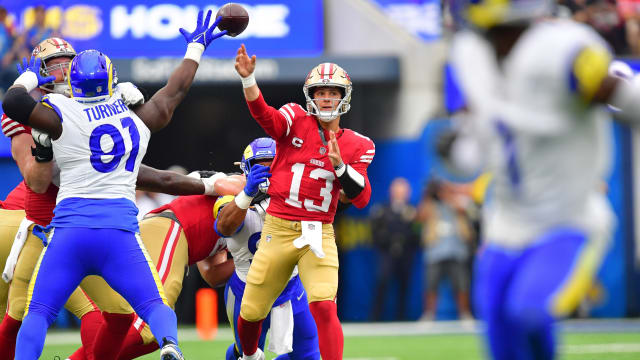 Sep 17, 2023; Inglewood, California, USA; San Francisco 49ers quarterback Brock Purdy (13) throws under pressure from Los Angeles Rams defensive tackle Kobie Turner (91) during the first half at SoFi Stadium. Mandatory Credit: Gary A. Vasquez-USA TODAY Sports