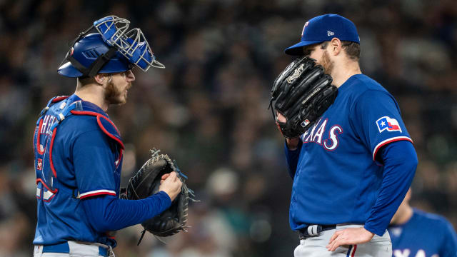 Sep 28, 2023; Seattle, Washington, USA; Texas Rangers starting pitcher Jordan Montgomery (52) and catcher Jonah Heim (28) meet at the mound during the fourth inning against the Seattle Mariners at T-Mobile Park. Mandatory Credit: Stephen Brashear-USA TODAY Sports