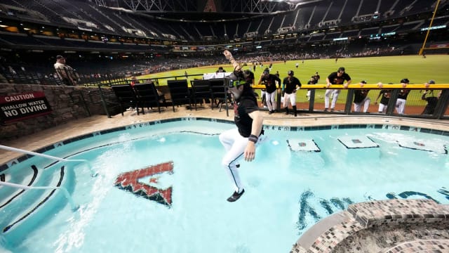 Diamondbacks outfielder Corbin Carroll is the first player to jump into the Chase Field pool as the team celebrates clinching a postseason berth via Wild Card.