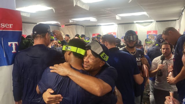 Third-base coach Tony Beasley hugs pitcher Jose Leclerc during the Texas Rangers locker room celebration after sweeping the Tampa Bay Rays in the AL Wild Card series Wednesday at Tropicana Field.