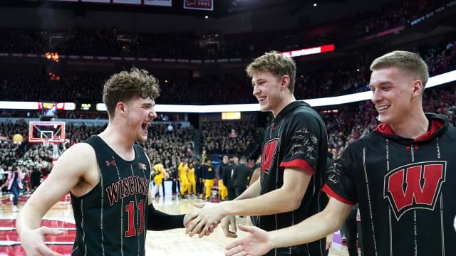 Feb 14, 2023; Madison, Wisconsin, USA; Wisconsin Badgers guard Max Klesmit (11) celebrates a win over the Michigan Wolverines with teammates Markus Ilver (center) and Isaac Lindsey (right) during the second half at the Kohl Center. Mandatory Credit: Kayla Wolf-USA TODAY Sports